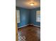 Bedroom with dark hardwood floors and blue walls at 5414 E 11Th St, Indianapolis, IN 46219