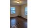 Bright bedroom featuring dark hardwood flooring at 5414 E 11Th St, Indianapolis, IN 46219