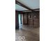 Living room with wood paneled walls and hardwood floors at 5414 E 11Th St, Indianapolis, IN 46219