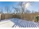 Snowy backyard with a storage shed and wooden fence at 7421 Country Brook Dr, Indianapolis, IN 46260