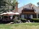 Spacious backyard patio with seating area, umbrella, and lush landscaping at 7569 Farm View E Cir, Indianapolis, IN 46256