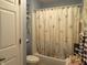 Bathroom with shower/tub combo and seashell decor at 7569 Farm View E Cir, Indianapolis, IN 46256