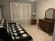 Neutral bedroom with natural light, a futon, dresser, and shelving at 7569 Farm View E Cir, Indianapolis, IN 46256