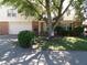 Ranch house with mature tree, landscaping, and a two-car garage at 7569 Farm View E Cir, Indianapolis, IN 46256