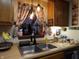 Kitchen with double sink, farmhouse-style décor and breakfast bar at 7569 Farm View E Cir, Indianapolis, IN 46256