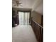 A second story loft area featuring plush carpeting, balcony access, and natural light at 7569 Farm View E Cir, Indianapolis, IN 46256