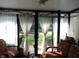 Bright sunroom with plenty of windows and comfortable seating at 7569 Farm View E Cir, Indianapolis, IN 46256