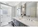 Modern bathroom featuring a double vanity, decorative tile, and glass-enclosed shower, offering a stylish and functional design at 7830 Ridgeland Dr, Indianapolis, IN 46250