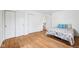 Bright bedroom with hardwood floors, closets, and a cozy bed with floral patterned comforter at 7830 Ridgeland Dr, Indianapolis, IN 46250