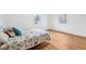 Cozy bedroom with hardwood floors, two windows, and a comfortable bed with a floral patterned comforter at 7830 Ridgeland Dr, Indianapolis, IN 46250