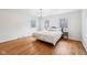 Bright bedroom with hardwood floors, a queen-sized bed, chandelier, and natural light from two windows at 7830 Ridgeland Dr, Indianapolis, IN 46250