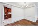 Dining room features hardwood floors and trim detailing, with a view into kitchen at 7830 Ridgeland Dr, Indianapolis, IN 46250