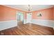 Inviting dining room with hardwood floors, decorative wainscoting, and elegant chandelier at 7830 Ridgeland Dr, Indianapolis, IN 46250