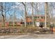 Beautiful brick home with black shutters, mature trees, and well-kept landscaping at 7830 Ridgeland Dr, Indianapolis, IN 46250