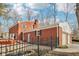 Rear exterior showcasing brick home, deck and fenced-in yard at 7830 Ridgeland Dr, Indianapolis, IN 46250