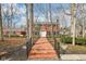 Stately two-story brick home with a red brick walkway and well-manicured landscaping at 7830 Ridgeland Dr, Indianapolis, IN 46250