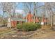 Brick home featuring black shutters, gray roof, and well-maintained landscaping at 7830 Ridgeland Dr, Indianapolis, IN 46250