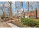 Stately brick home with black shutters, a brick walkway, mature trees, and manicured landscaping at 7830 Ridgeland Dr, Indianapolis, IN 46250