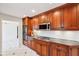 Updated kitchen features wood cabinets, modern appliances, and tiled flooring at 7830 Ridgeland Dr, Indianapolis, IN 46250