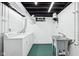 Functional laundry area with washer, dryer, and utility sink at 7830 Ridgeland Dr, Indianapolis, IN 46250