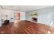 Spacious living room with hardwood floors, fireplace, and blue paneled walls at 7830 Ridgeland Dr, Indianapolis, IN 46250
