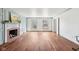 Bright living room featuring hardwood floors, large windows, and a charming fireplace at 7830 Ridgeland Dr, Indianapolis, IN 46250