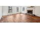 Spacious living room features hardwood floors, natural light, and a brick fireplace at 7830 Ridgeland Dr, Indianapolis, IN 46250