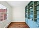 Home office features hardwood floors, large window, and custom built-in bookshelves at 7830 Ridgeland Dr, Indianapolis, IN 46250