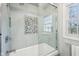 Shower-tub combination with stylish tile surround and glass door at 7830 Ridgeland Dr, Indianapolis, IN 46250