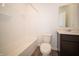 Clean bathroom with shower-tub combo, dark vanity with modern fixtures, and wood-look flooring at 801 Blaine Dr, Whiteland, IN 46184