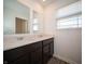 Bathroom with a double sink vanity, quartz countertop and wood-look flooring at 801 Blaine Dr, Whiteland, IN 46184