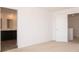 Bedroom with neutral carpet, neutral walls, and an open doorway to an attached bathroom and a view of the staircase at 801 Blaine Dr, Whiteland, IN 46184