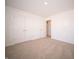 A bedroom featuring neutral carpet, white walls, and a double door closet for ample storage at 801 Blaine Dr, Whiteland, IN 46184