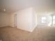 Spacious carpeted bedroom featuring white walls, an open doorway, and a bright window at 801 Blaine Dr, Whiteland, IN 46184