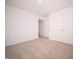 A bedroom featuring neutral carpet, white walls, and a double door closet for ample storage at 801 Blaine Dr, Whiteland, IN 46184