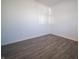 Well-lit bedroom with wood-look floors, white walls, and a large window for natural light at 801 Blaine Dr, Whiteland, IN 46184