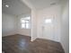 Bright entryway with a white front door, wood-look floors, and ample natural light from large windows at 801 Blaine Dr, Whiteland, IN 46184