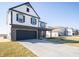 Two-story home features a modern exterior with a dark garage and a well-manicured front yard at 801 Blaine Dr, Whiteland, IN 46184