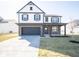 Charming two-story home featuring a modern exterior with black trim and attached two-car garage at 801 Blaine Dr, Whiteland, IN 46184