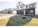 Exterior of home with dark trim, showcasing the garage, front yard, and proximity to neighborhood houses at 801 Blaine Dr, Whiteland, IN 46184