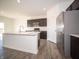 Bright kitchen features stainless steel appliances, large island, and dark cabinets at 801 Blaine Dr, Whiteland, IN 46184