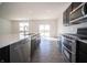 Well-equipped kitchen with stainless steel appliances, large island, and sliding glass doors to the yard at 801 Blaine Dr, Whiteland, IN 46184