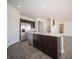 Stylish kitchen featuring stainless steel appliances, a spacious island, and dark cabinets at 801 Blaine Dr, Whiteland, IN 46184