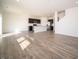 Spacious open-concept area featuring wood-look floors, and kitchen with a central island and modern appliances at 801 Blaine Dr, Whiteland, IN 46184