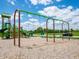 Playground area with swings and climbing structure against a backdrop of green trees and a blue sky at 801 Blaine Dr, Whiteland, IN 46184