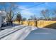 Snowy backyard with wooden fence and deck steps at 8810 Beechwood Ave, Indianapolis, IN 46219