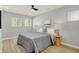 Bright bedroom with ceiling fan, neutral walls, and wood-look flooring at 8810 Beechwood Ave, Indianapolis, IN 46219
