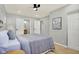 Well-lit bedroom with ceiling fan and access to en-suite bathroom at 8810 Beechwood Ave, Indianapolis, IN 46219