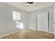 Simple bedroom with ceiling fan, neutral walls, and wood-look flooring at 8810 Beechwood Ave, Indianapolis, IN 46219