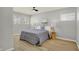 Bright bedroom with ceiling fan, neutral walls, and wood-look flooring at 8810 Beechwood Ave, Indianapolis, IN 46219
